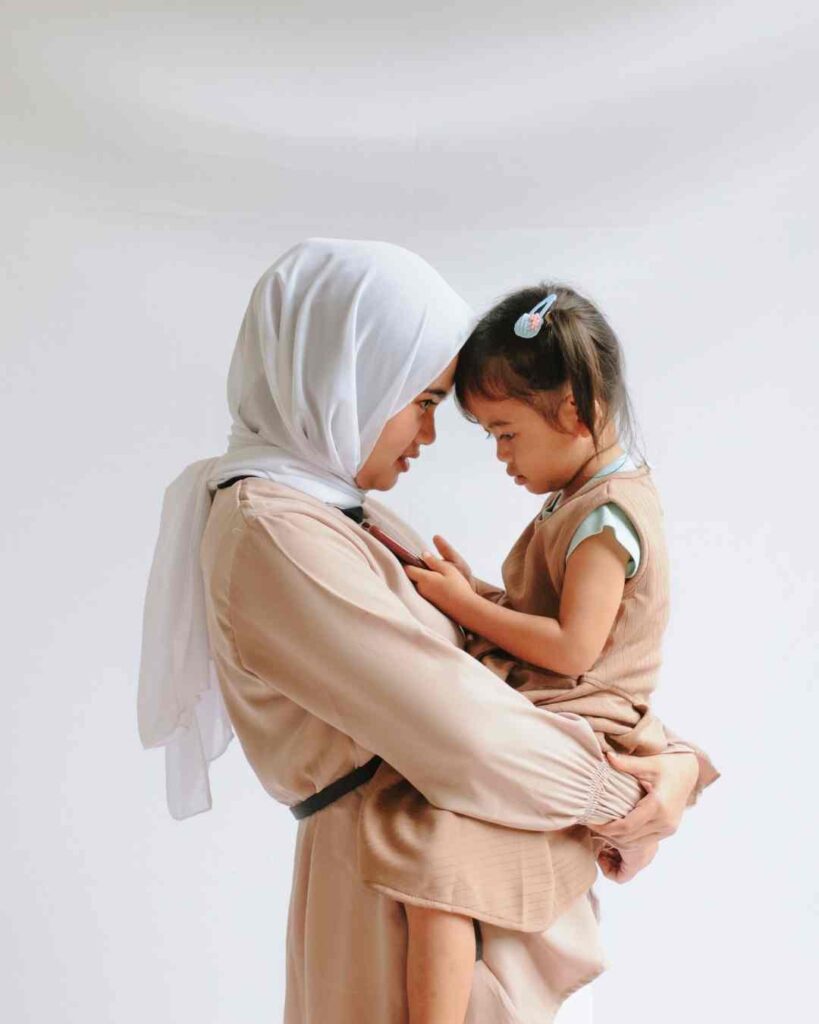 Mother carrying daughter